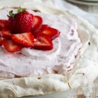 Whole strawberry cream angel pie topped with fresh strawberries.