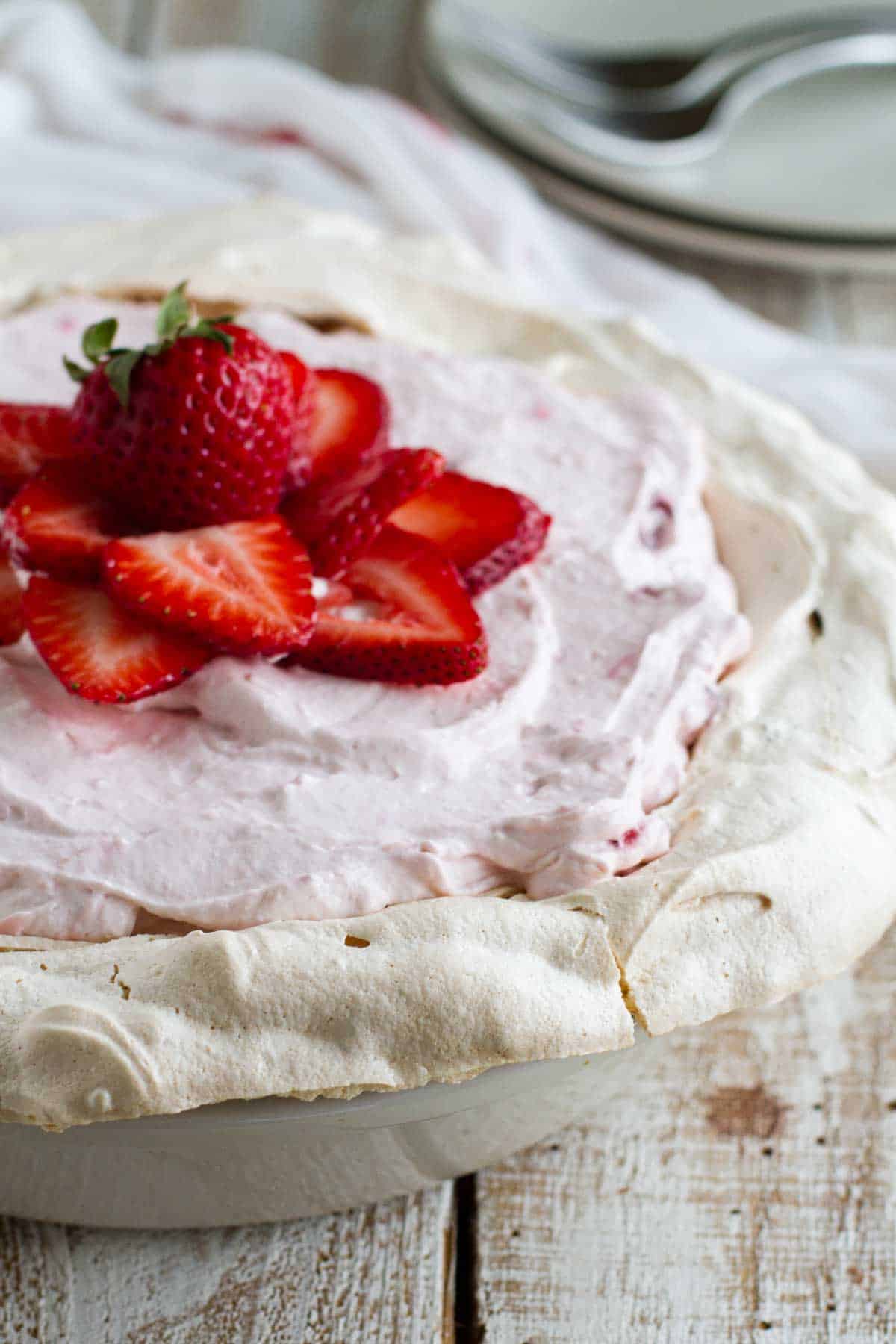 Whole strawberry cream angel pie topped with fresh strawberries.