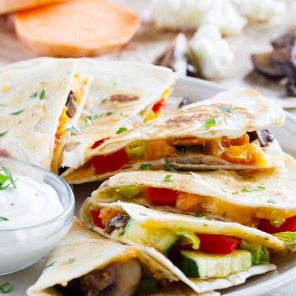 Slices of a veggie quesadilla fanned out on a plate.