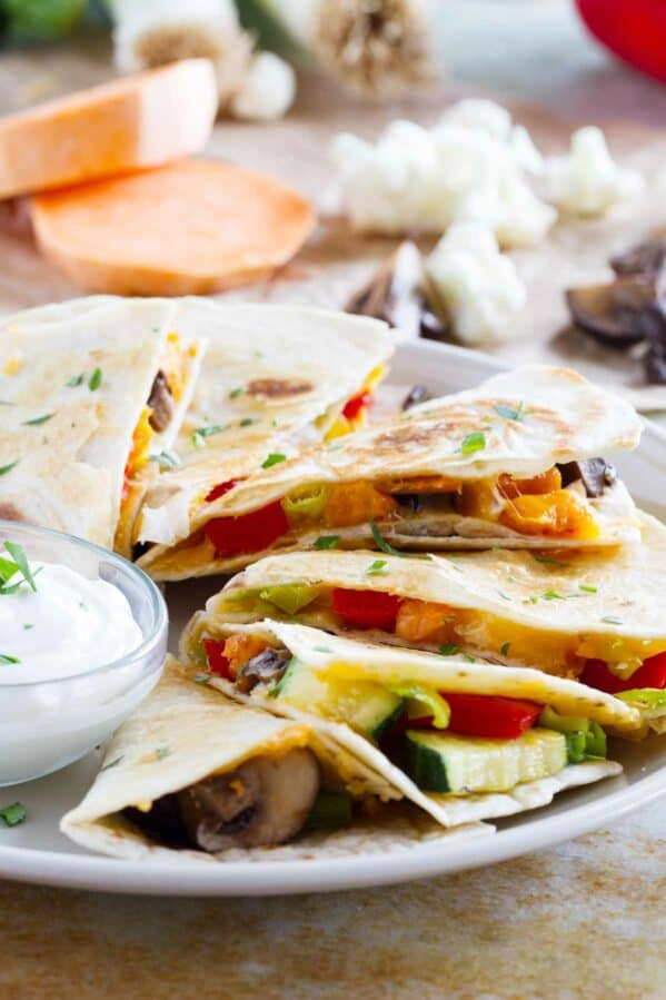 Slices of a veggie quesadilla fanned out on a plate.