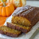 Loaf of pumpkin coconut bread with a few slices cut from it.