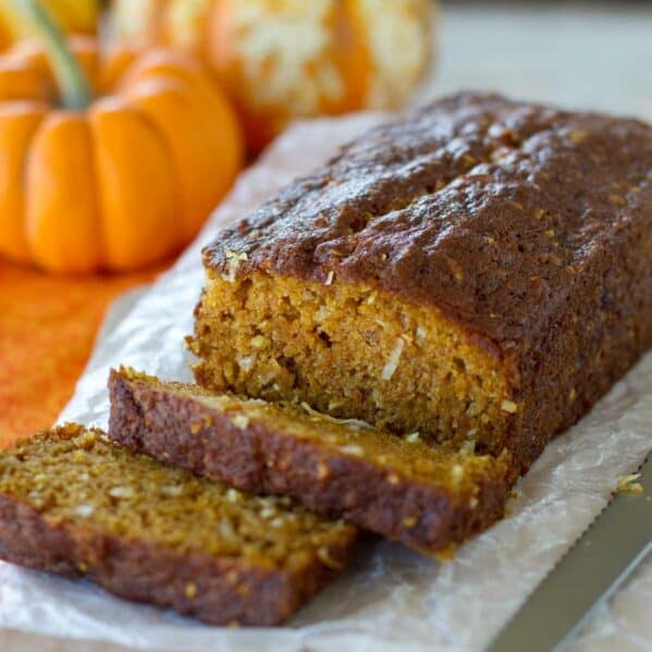 Loaf of pumpkin coconut bread with a few slices cut from it.