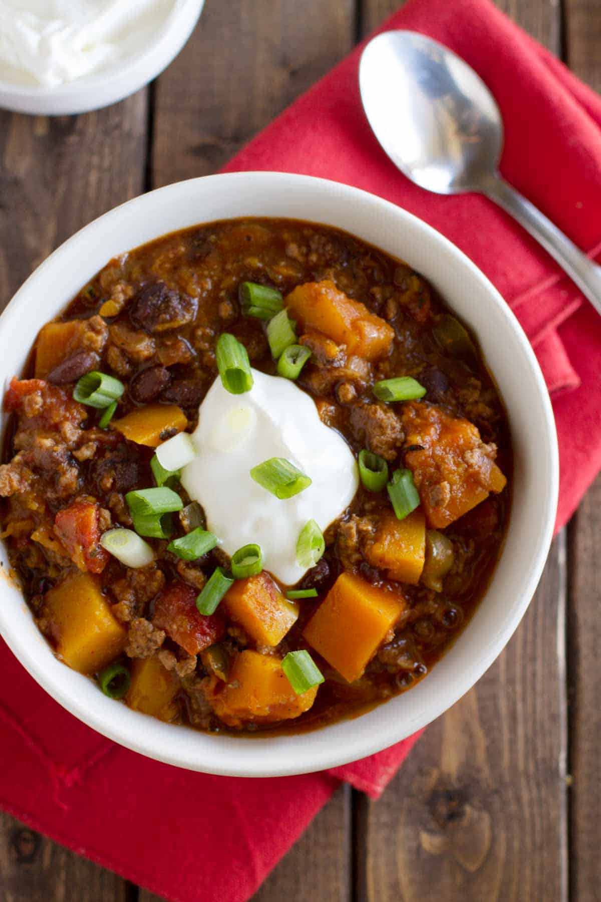Bowl of chili made with butternut squash, beans, and ground beef.