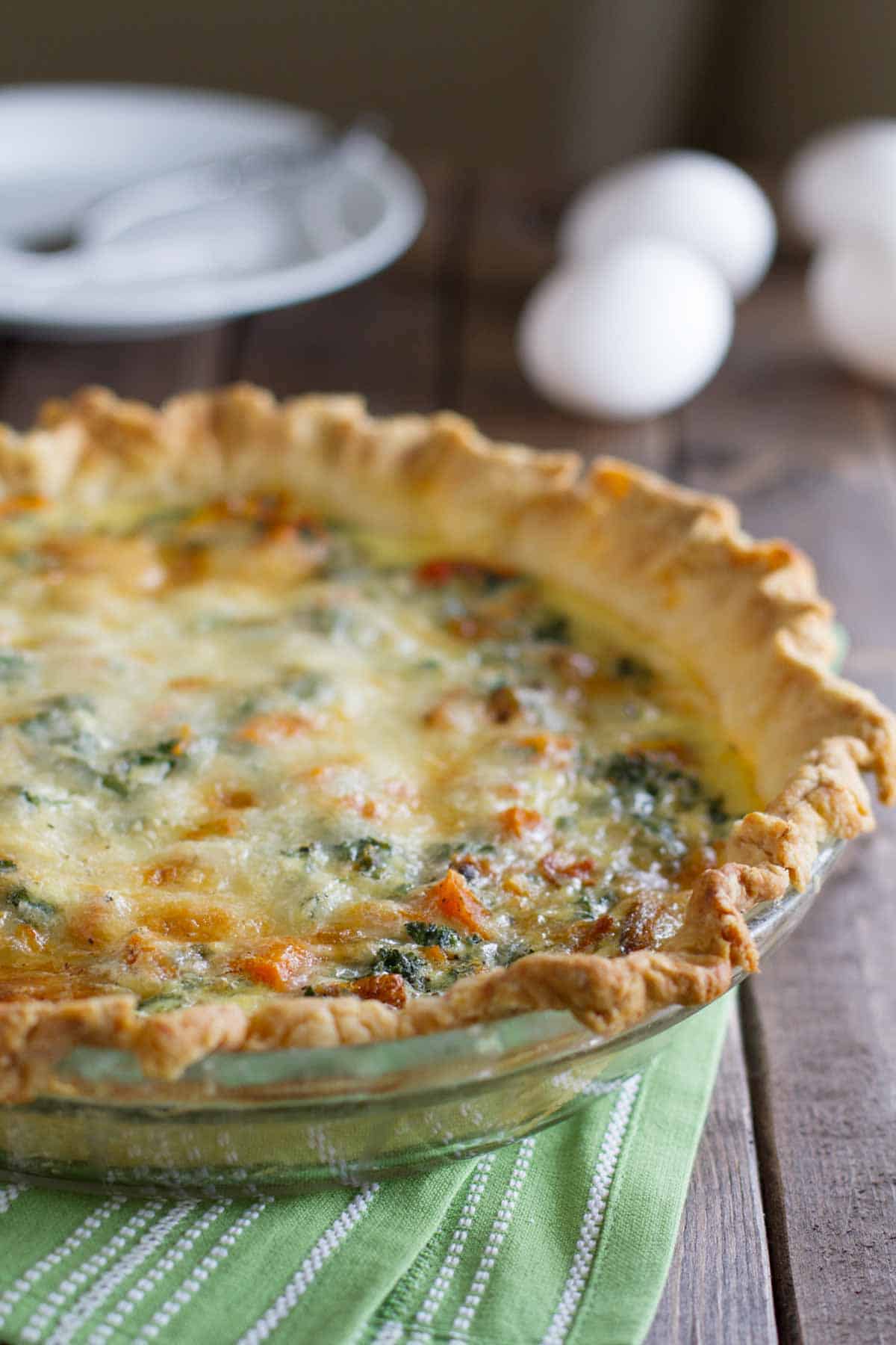 Full butternut squash quiche in a pie dish.