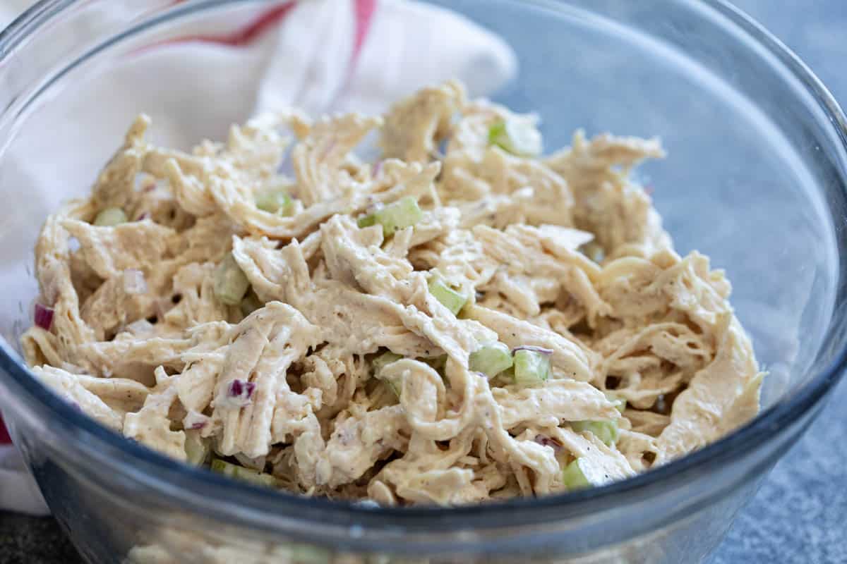 Classic chicken salad with shredded chicken in a bowl.