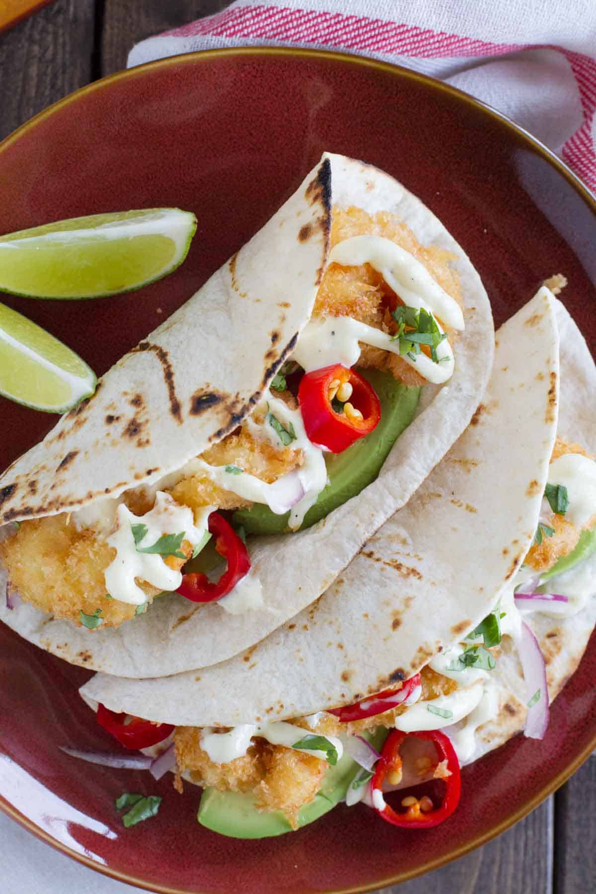 Crispy shrimp tacos on flour tortillas with homemade mayonnaise.