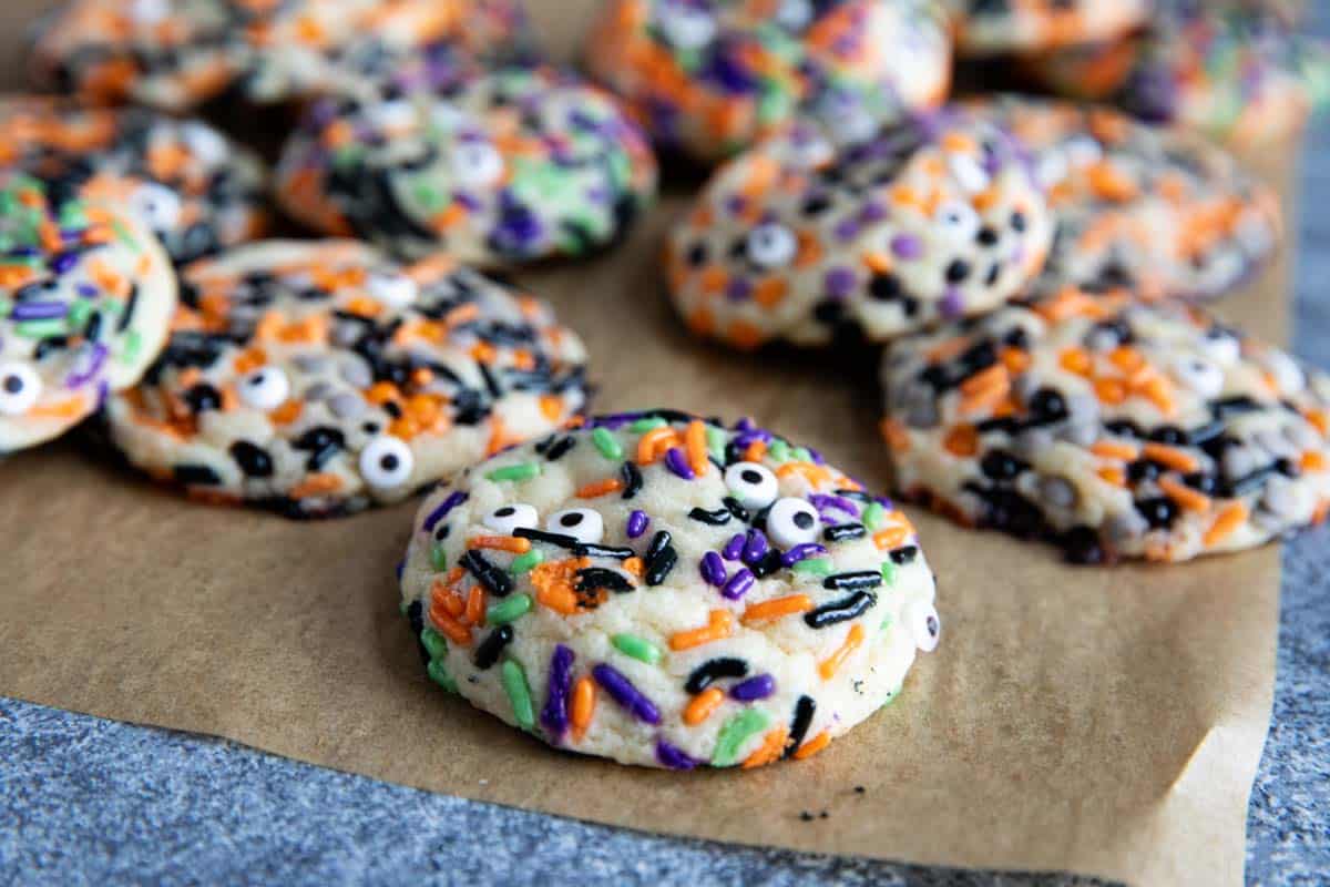 Stacked Halloween cookies with sprinkles and candy eyeballs.