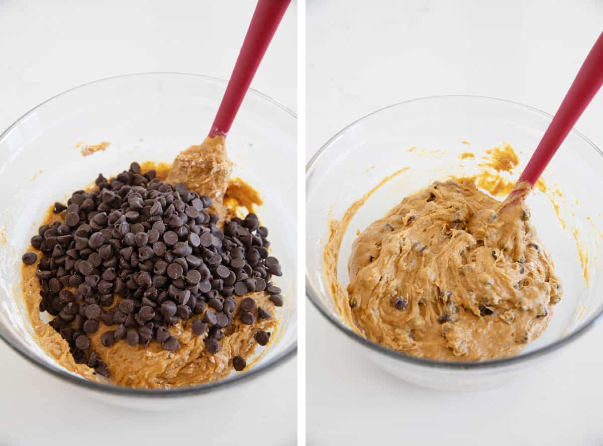 Adding chocolate chips to pumpkin cookie dough and mixing them in.