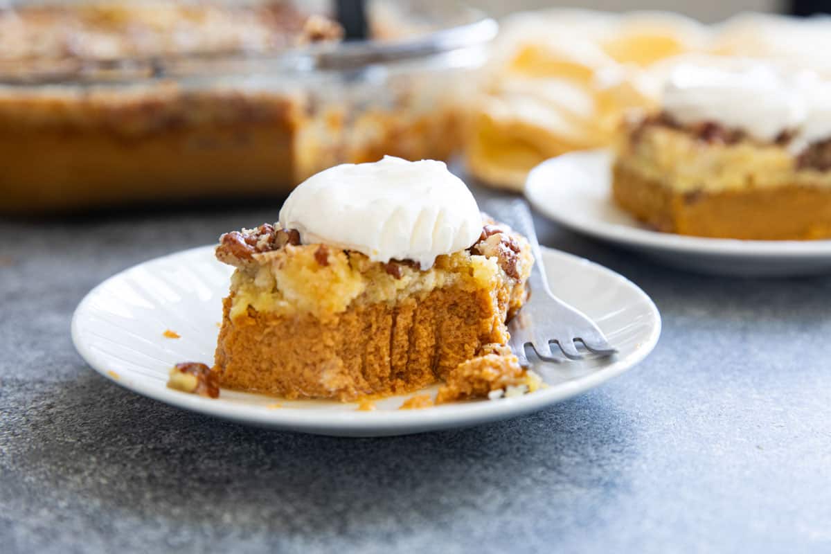 Piece of pumpkin dump cake with a bite taken from it.