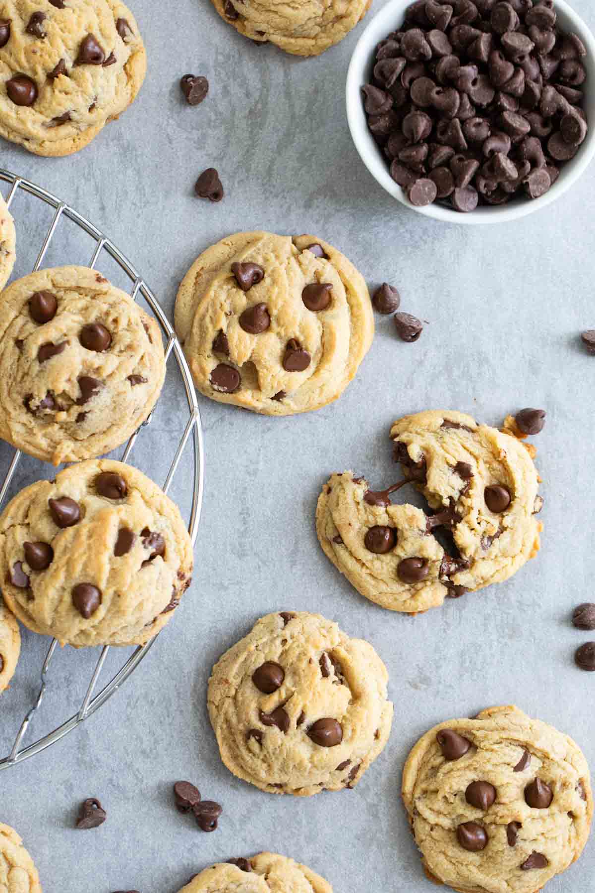 Chocolate chip pudding cookies with a bowl of chocolate chips.