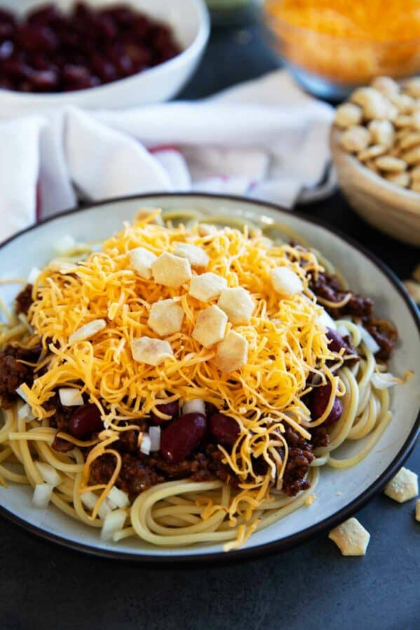 Plate filled with Cincinnati Chili served 5 way with cheese, onions, and kidney beans.