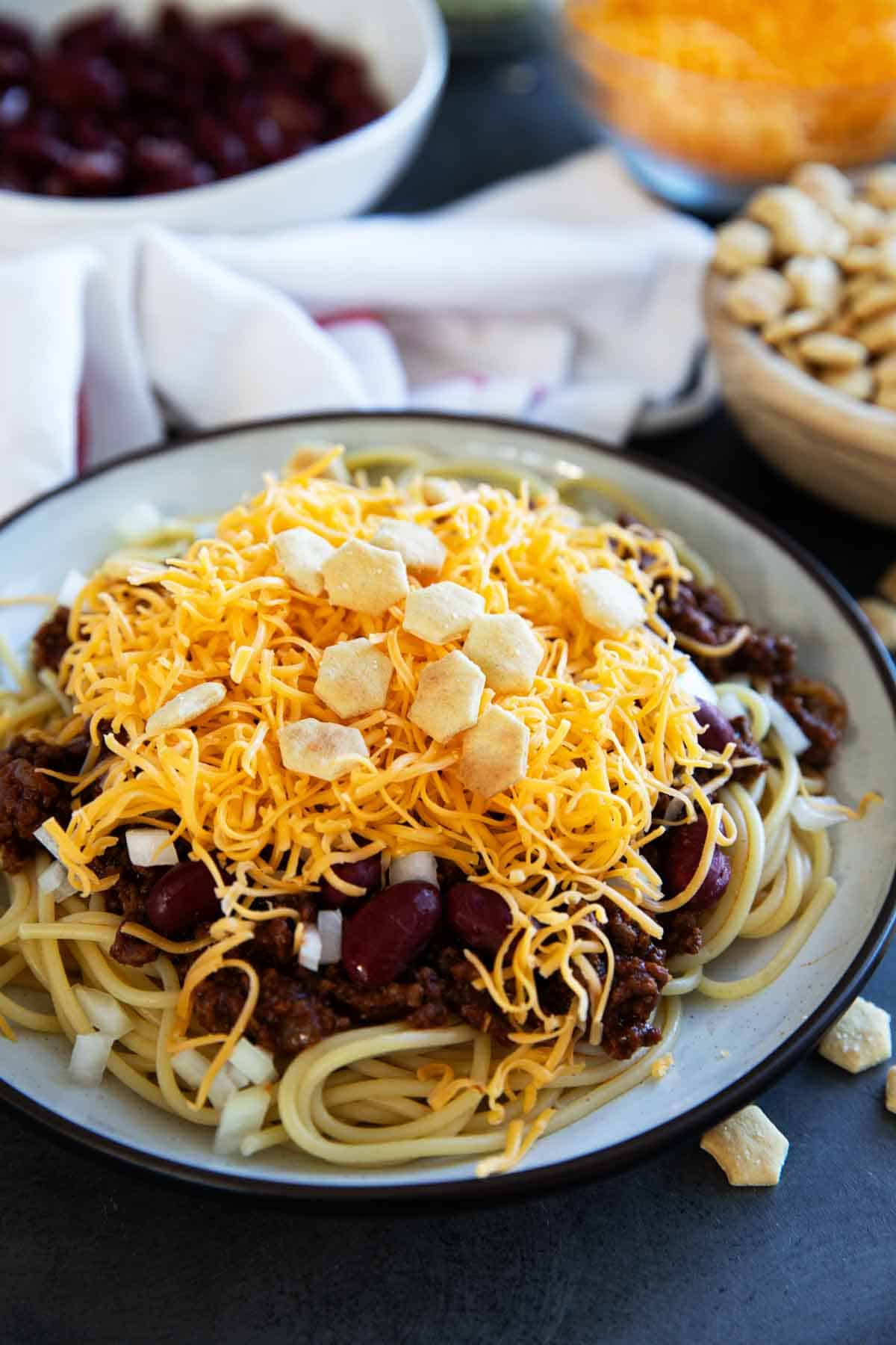 Plate filled with Cincinnati Chili served 5 way with cheese, onions, and kidney beans.