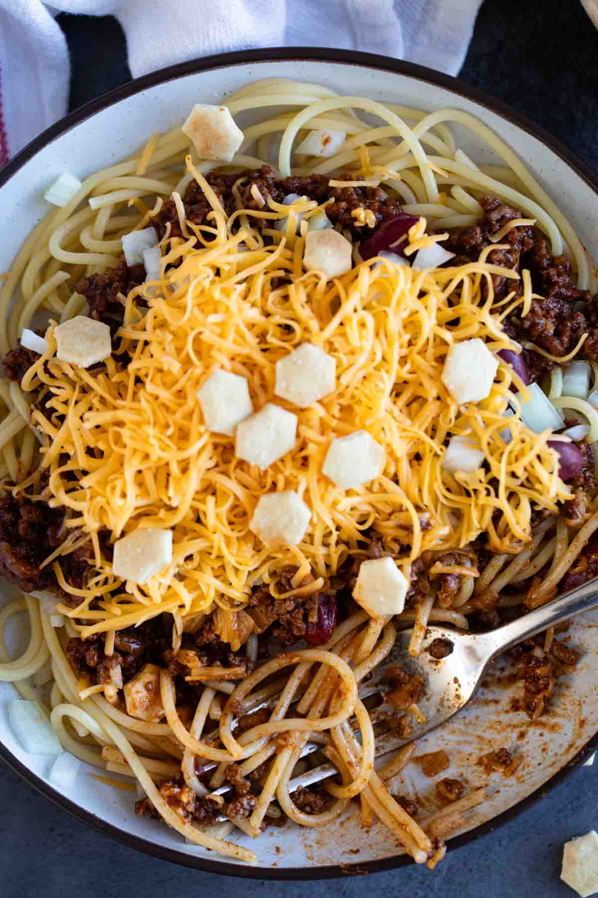 Spaghetti topped with Cincinnati Chili, beans, onions, and cheese.