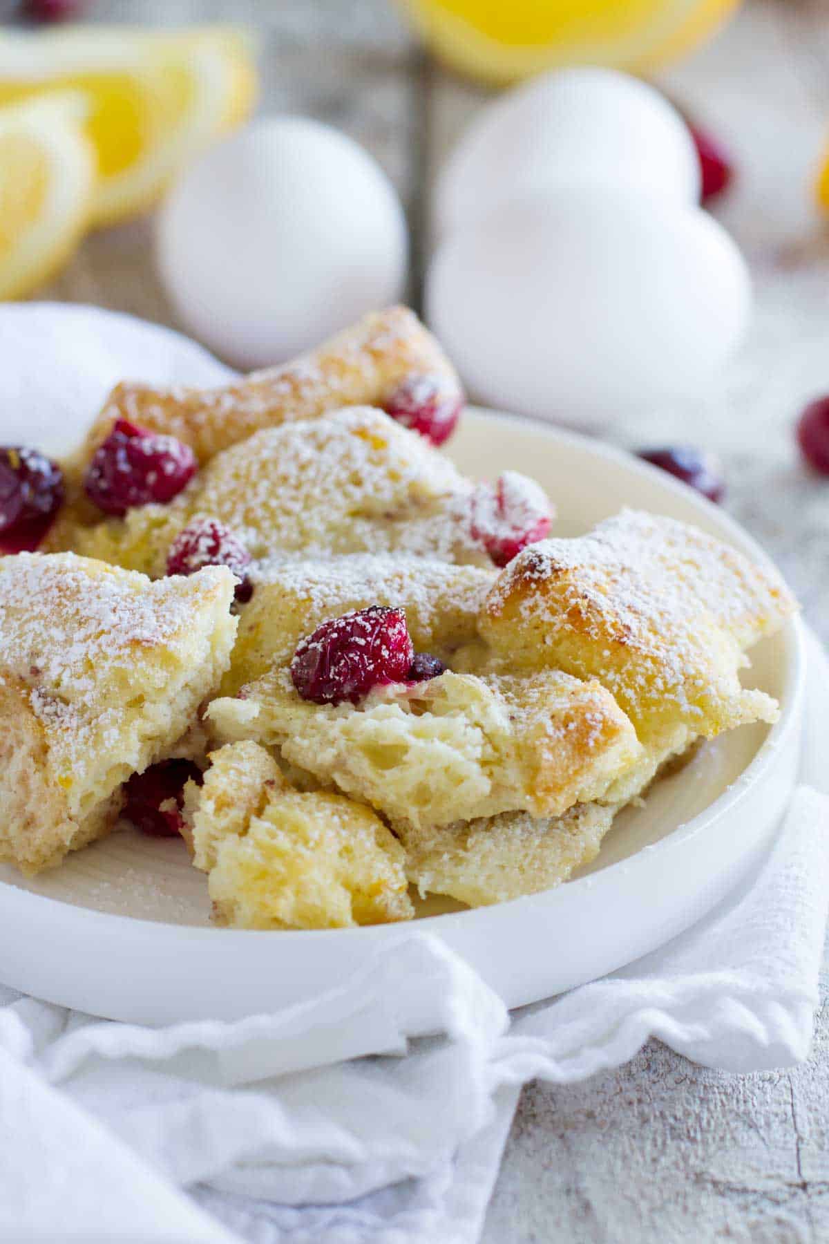Cranberry Orange Baked French Toast Casserole on a plate, made with fresh cranberries and oranges.