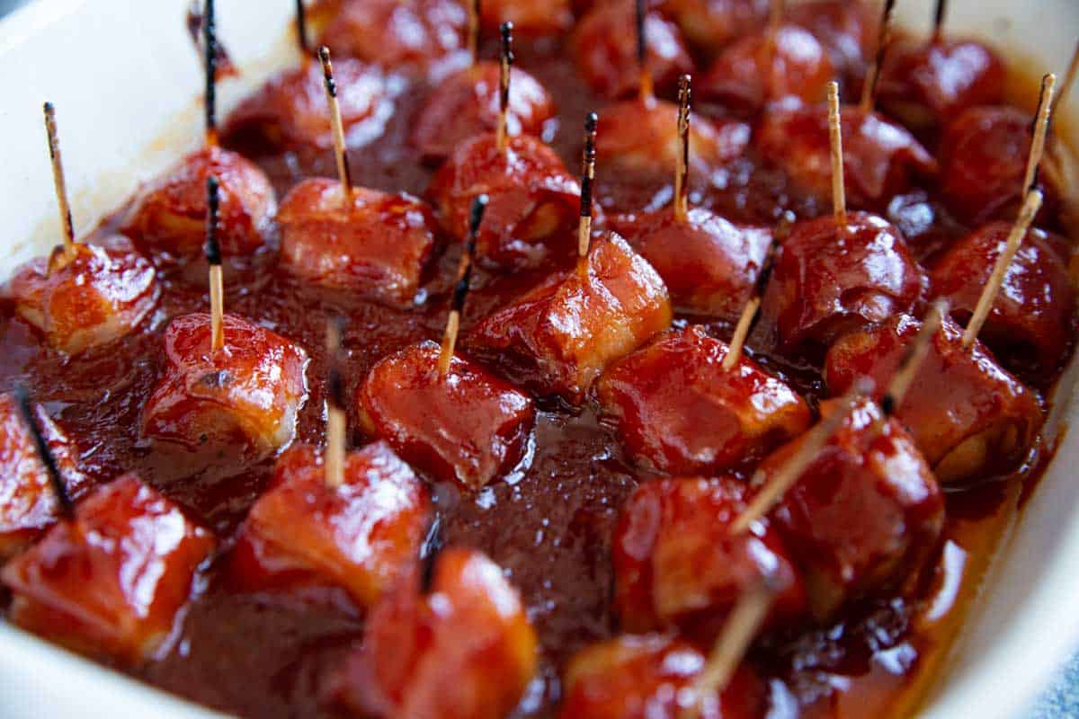 Bacon Wrapped Water Chestnuts baked in barbecue sauce for a delicious appetizer.