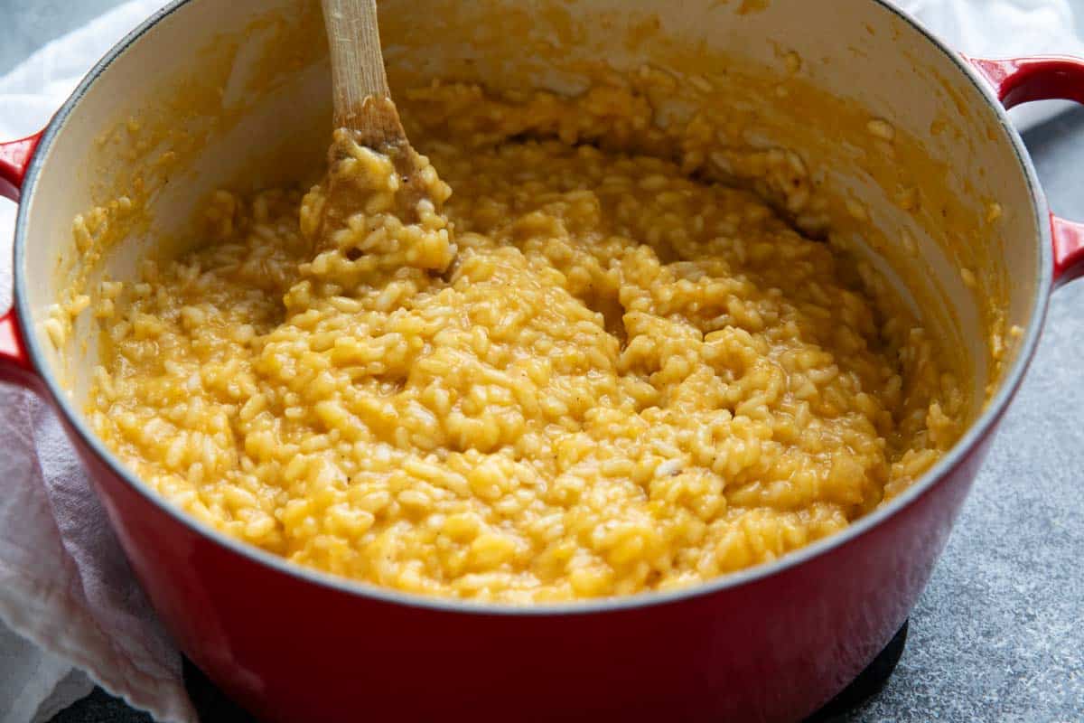 Dutch oven filled with butternut squash risotto.