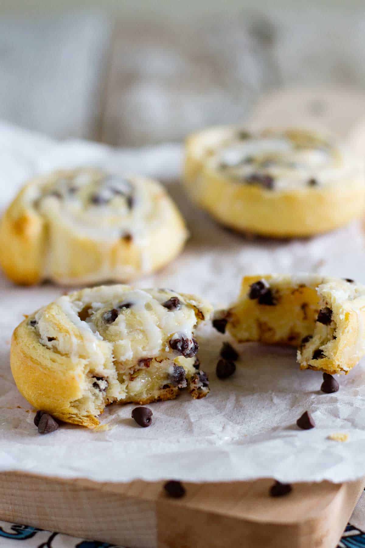 Chocolate chip crescent roll cookie torn in half to show interior texture.