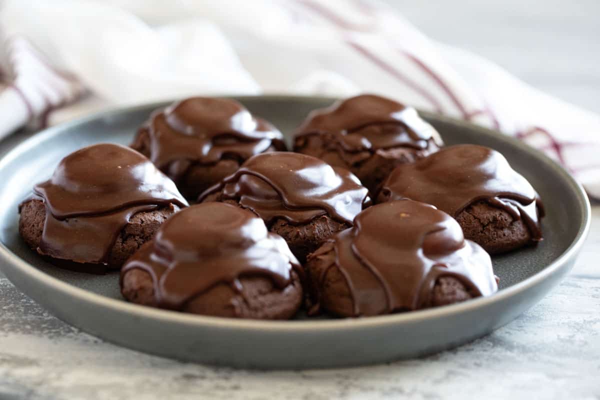 Chocolate Marshmallow Cookies covered in chocolate glaze on a plate.