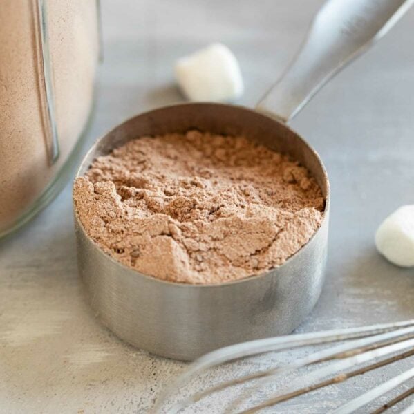 Measuring cup filled with homemade hot chocolate mix.