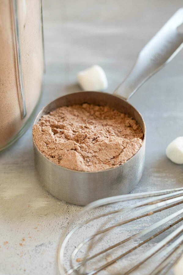 Measuring cup filled with homemade hot chocolate mix.