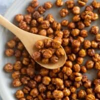 Roasted chickpeas on a plate with a spoon.