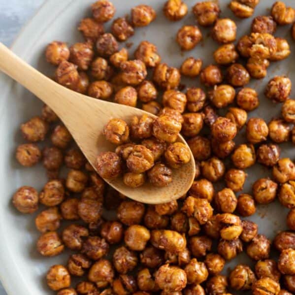 Roasted chickpeas on a plate with a spoon.