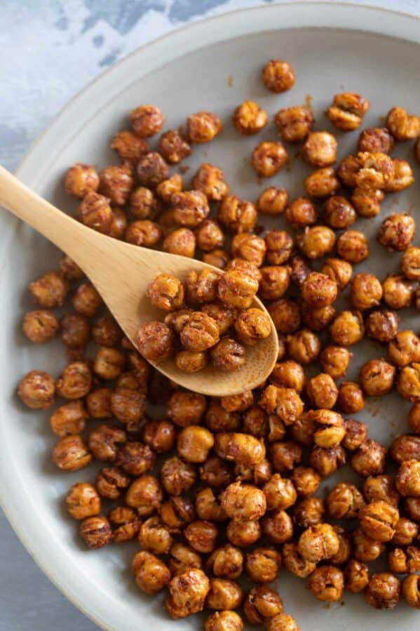 Roasted chickpeas on a plate with a spoon.