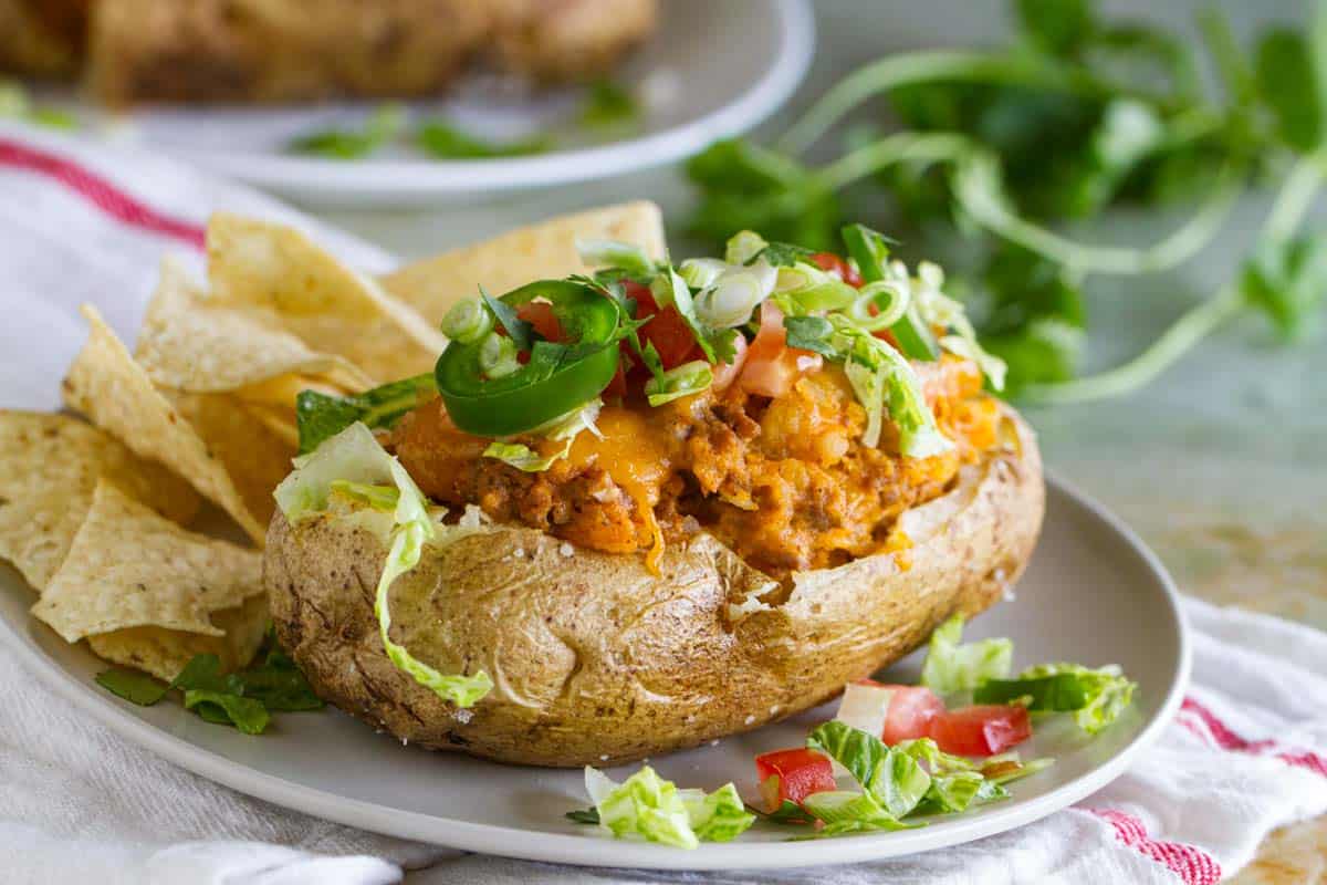 Taco stuffed potatoes topped with taco toppings.