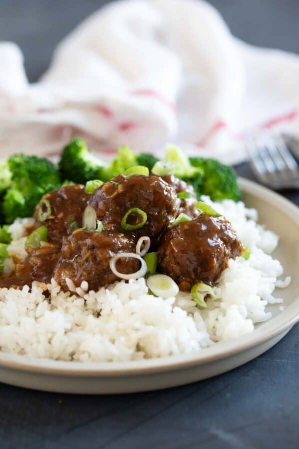 Asian meatballs over rice with steamed broccoli.
