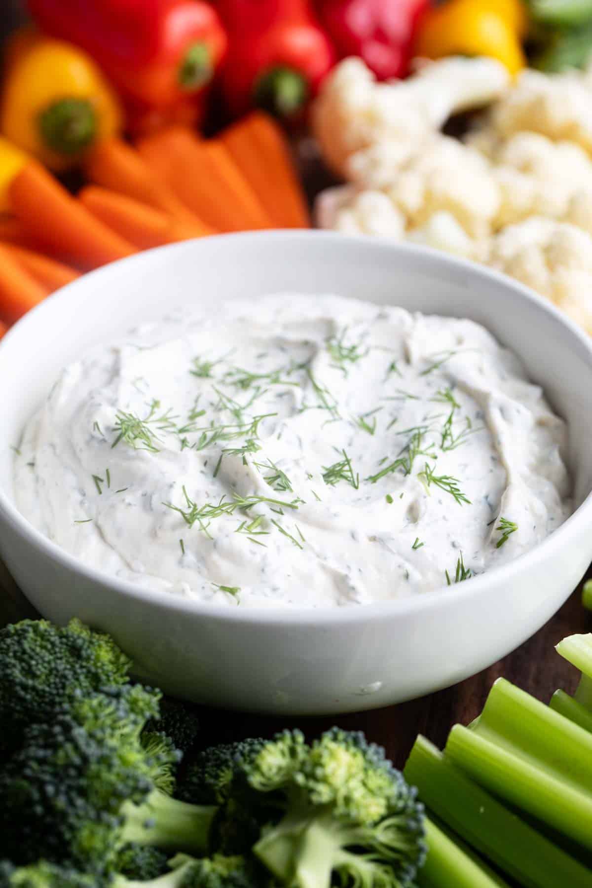 Bowl of dill dip topped with fresh dill.