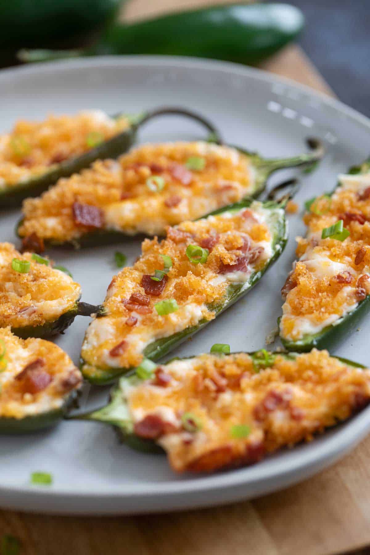 Jalapeño Poppers topped with breadcrumbs and bacon.