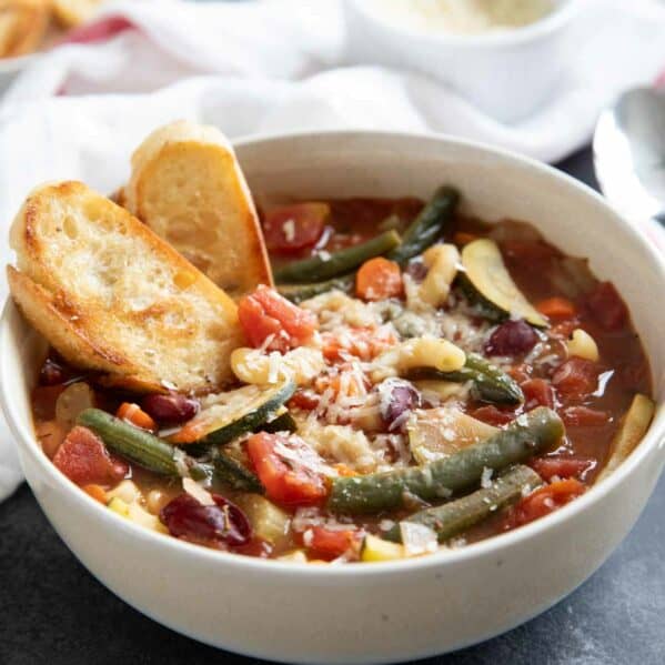 Bowl of minestrone soup with toasted bread.