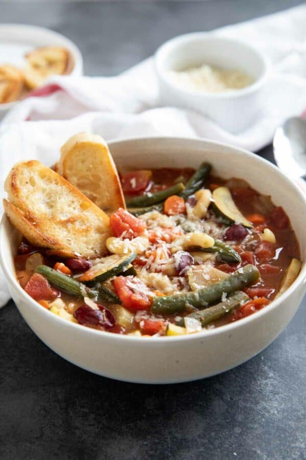 Bowl of minestrone soup with toasted bread.