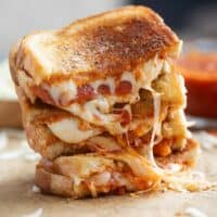 Pizza grilled cheese stacked on top of each other.