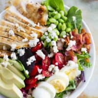 Cobb salad with grilled chicken, tomatoes, eggs, edamame, bacon, and avocado.