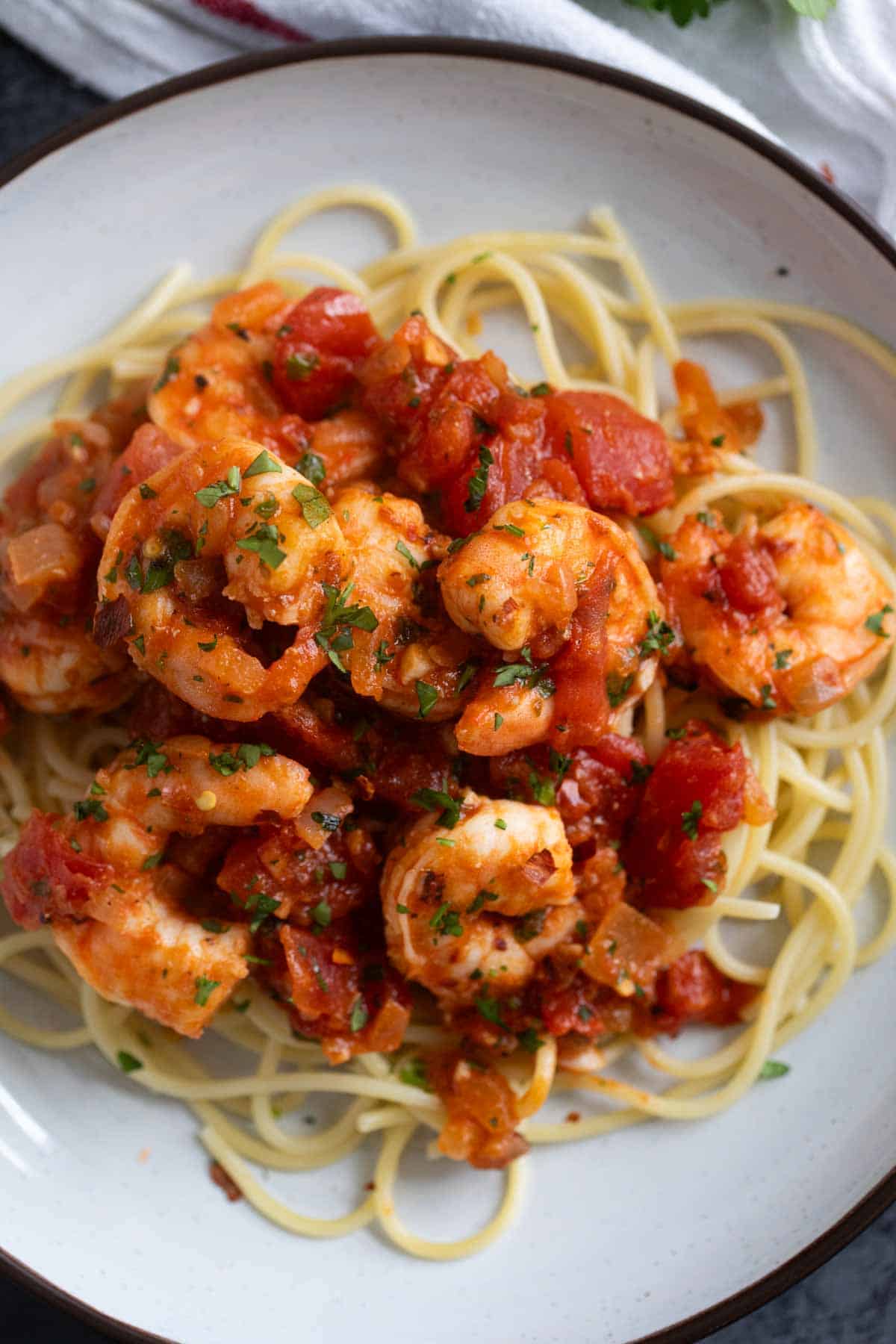 Shrimp Fra Diavolo on top of spaghetti noodles.
