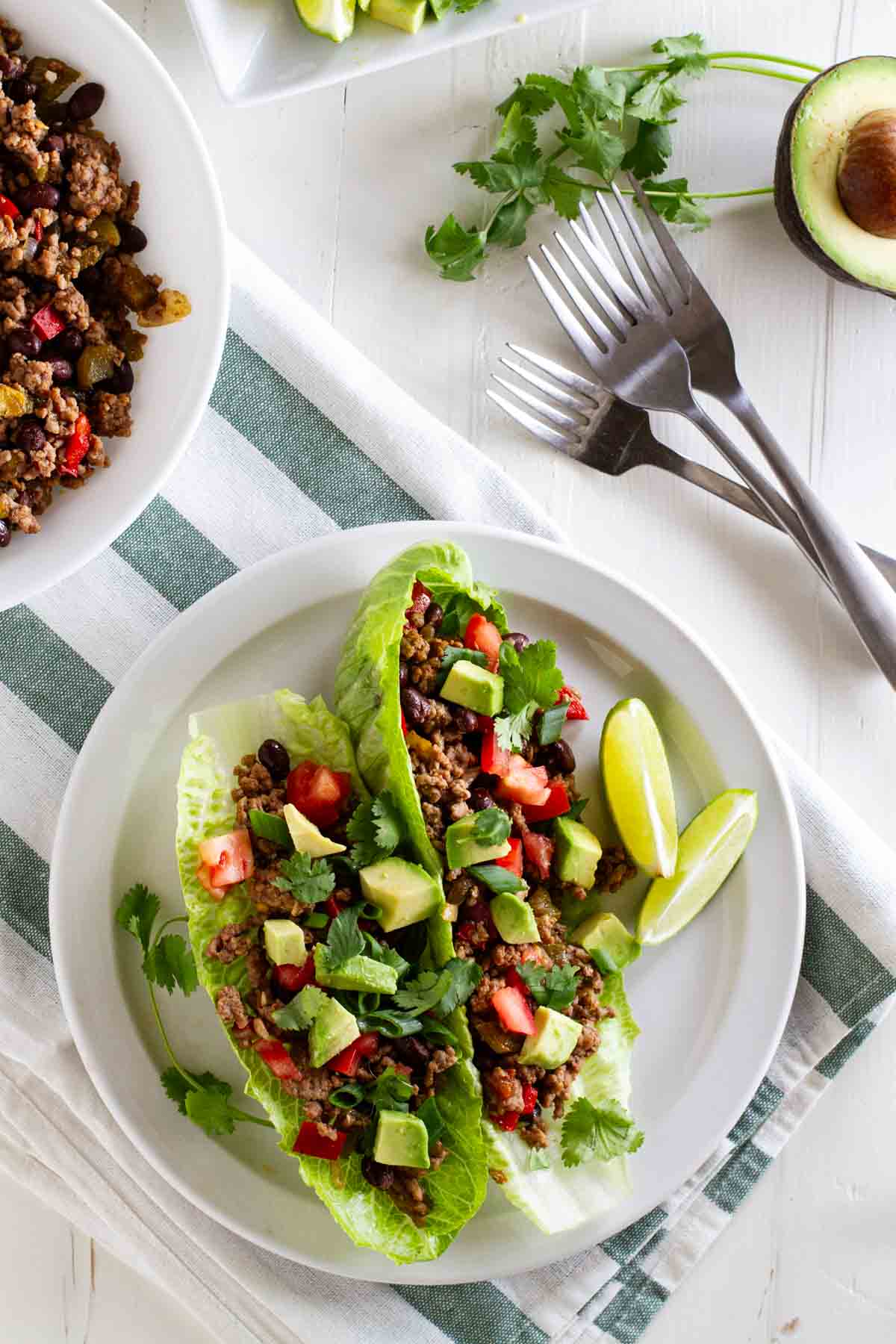 Taco lettuce wraps on a plate with forks.