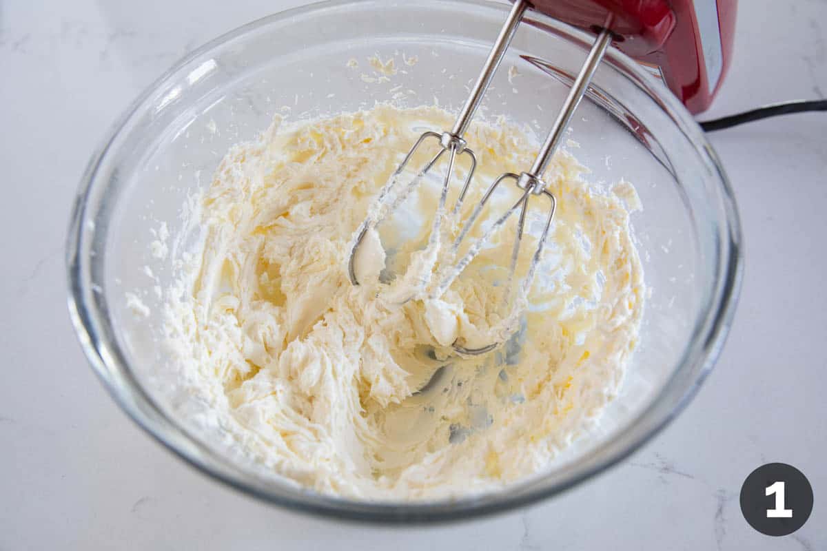 Beating cream cheese to soften.