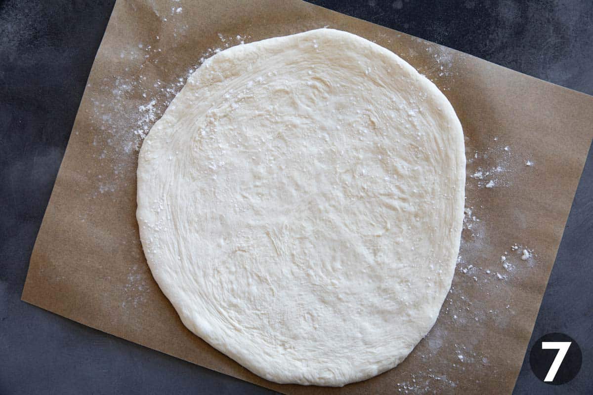 Artisan pizza dough on a piece of parchment paper.