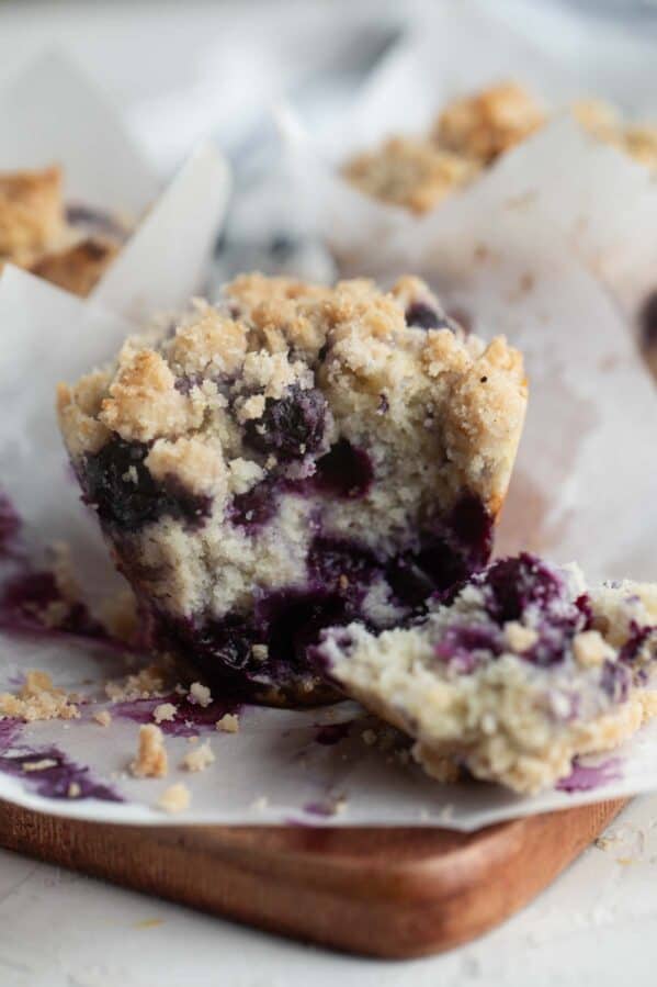 Blueberry muffin torn in half to show interior texture of the muffin.