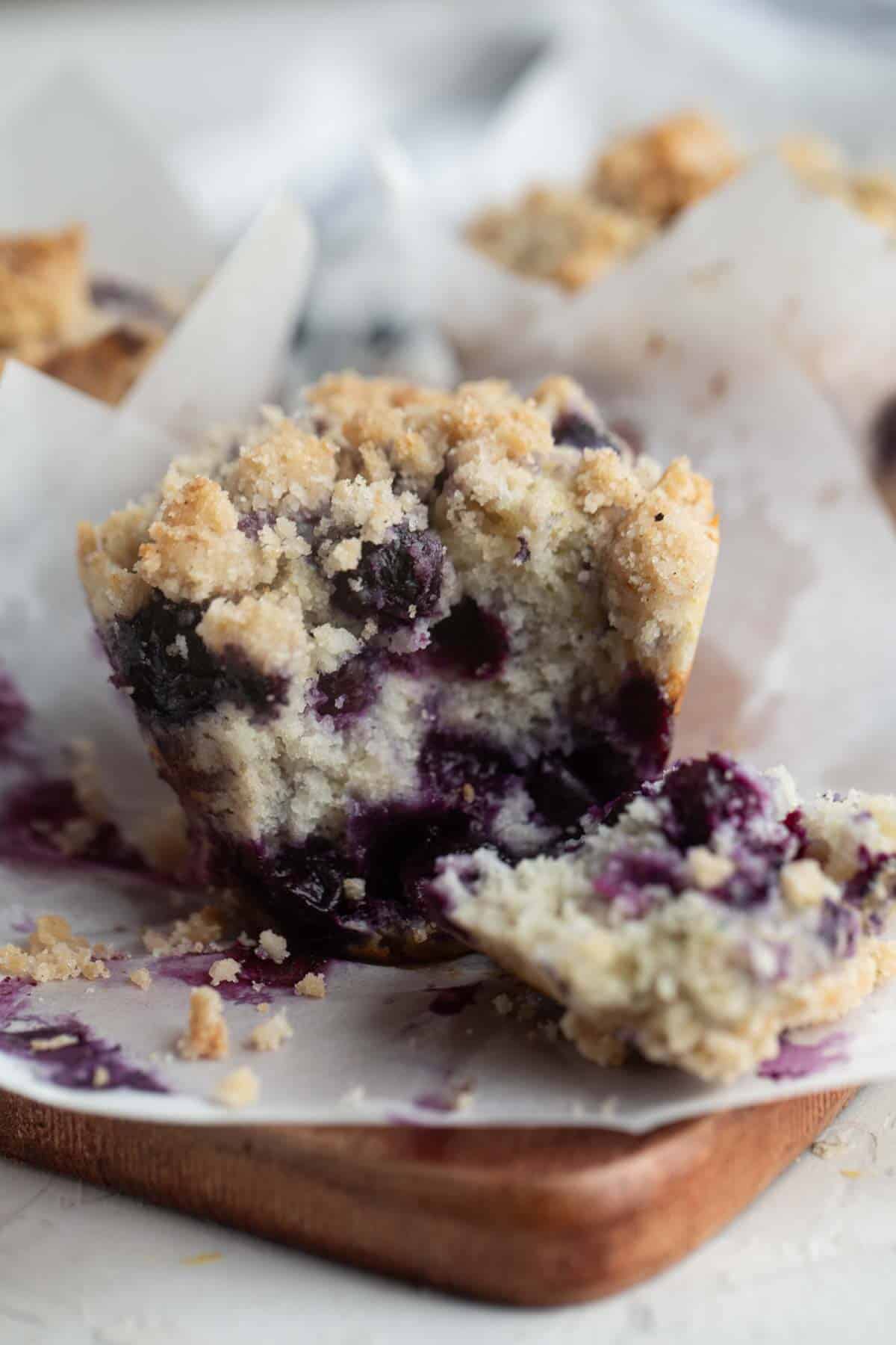 Blueberry muffin torn in half to show interior texture of the muffin.