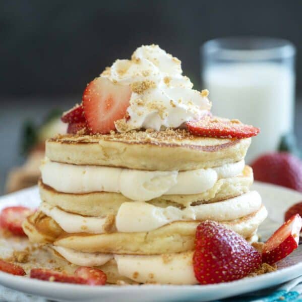 Cheesecake pancakes with cheesecake filling, topped with strawberries.