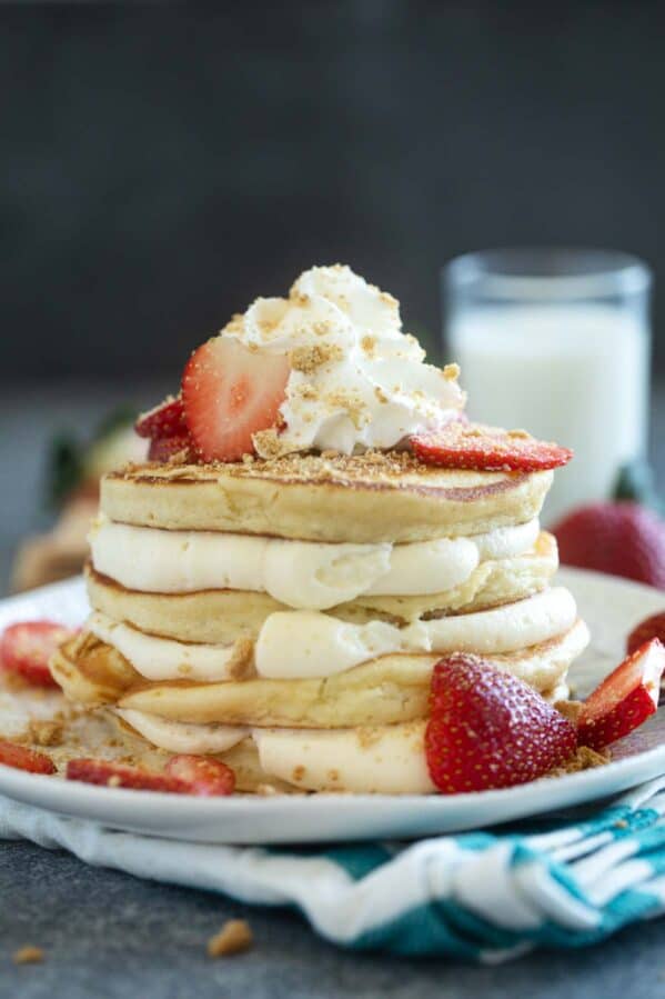 Cheesecake pancakes with cheesecake filling, topped with strawberries.