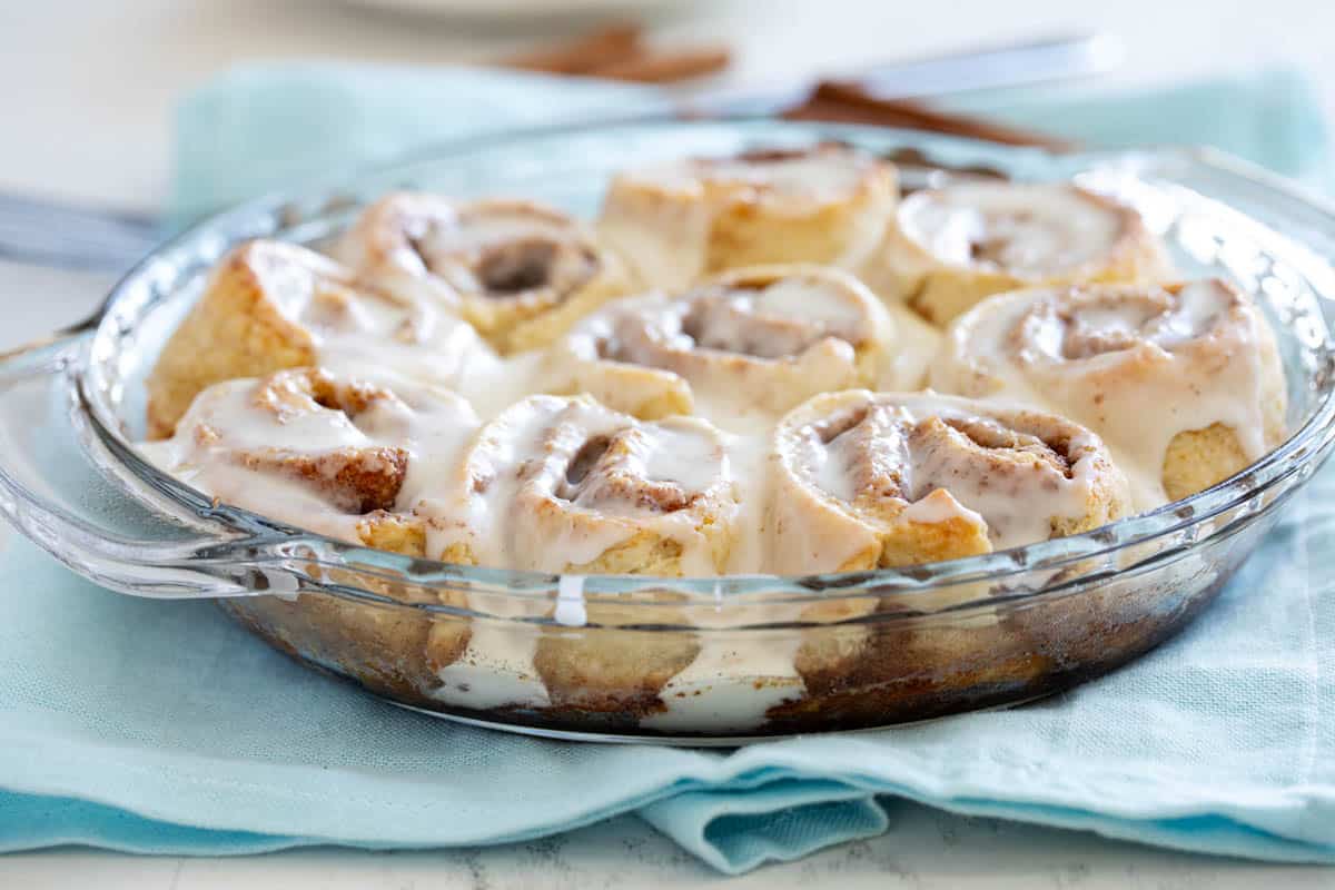 Cinnamon biscuits topped with icing in a pie dish.