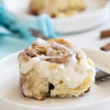 Cinnamon Biscuit on a plate, topped with icing.