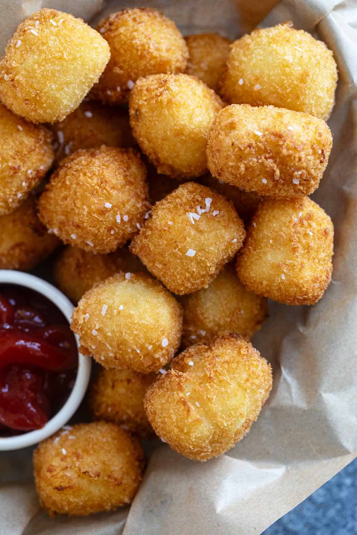 Basket filled with homemade tater tots and ketchup.