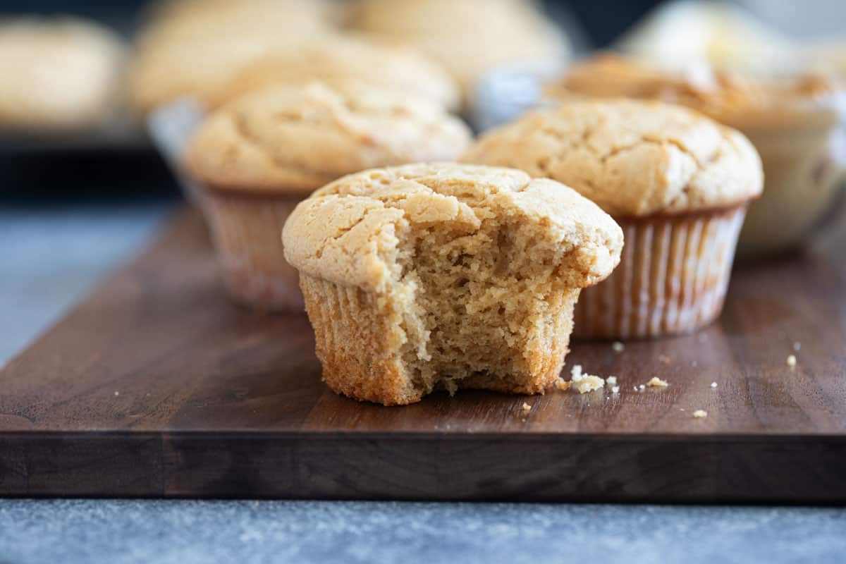 Peanut Butter Muffins on a cutting board with a bite taken from one of them.