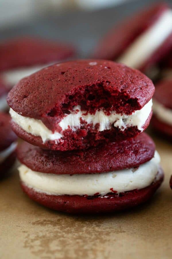Two red velvet whoopie pies stacked on top of each other.