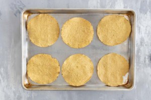 Tostada shells on a baking sheet.