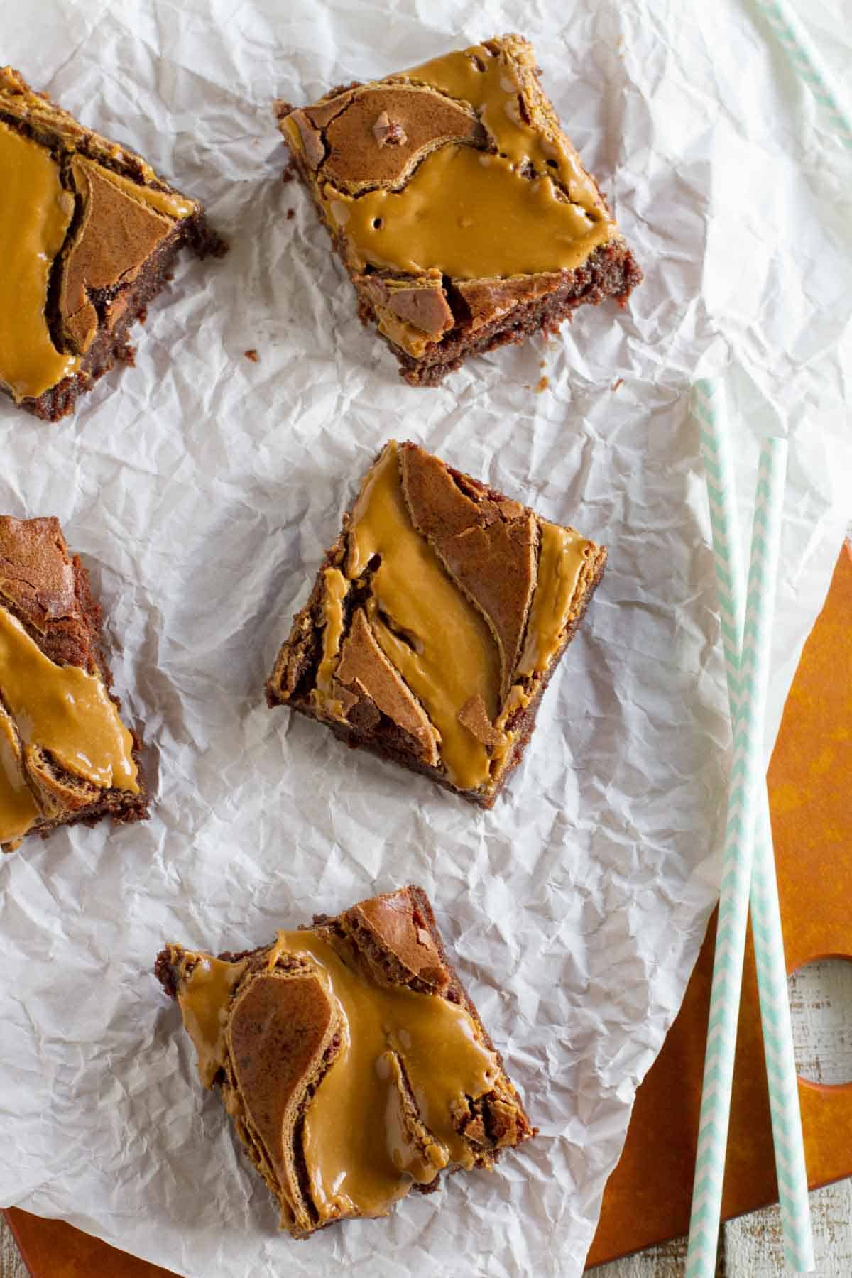 Biscoff brownies set out on a piece of parchment paper.
